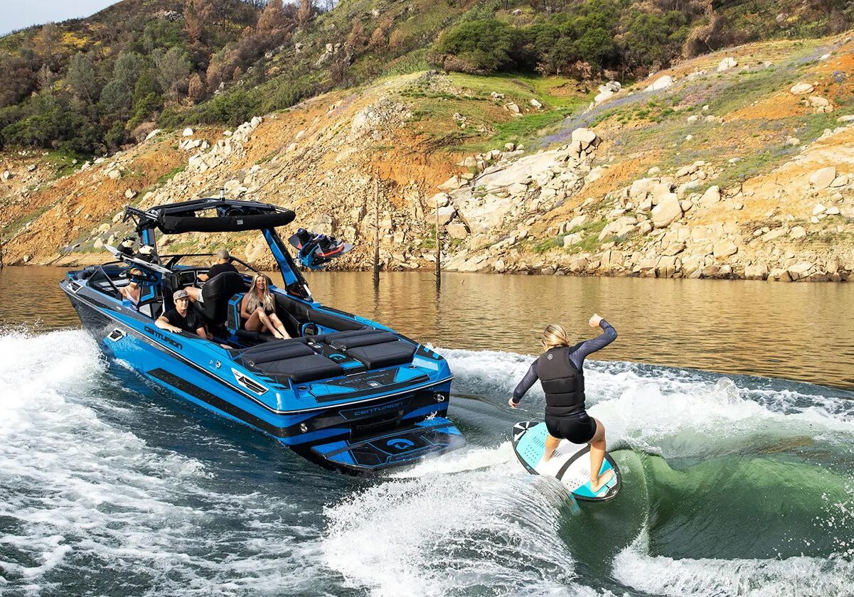 Wakeboarding behind a blue boat